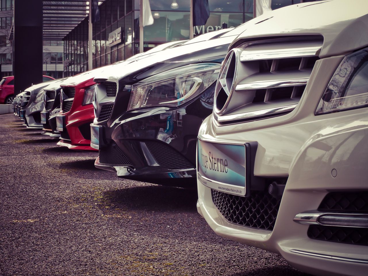 Crafting Captivating Headlines: Your awesome post title goes here Luxury cars lined up at an outdoor dealership, showcasing sleek designs.